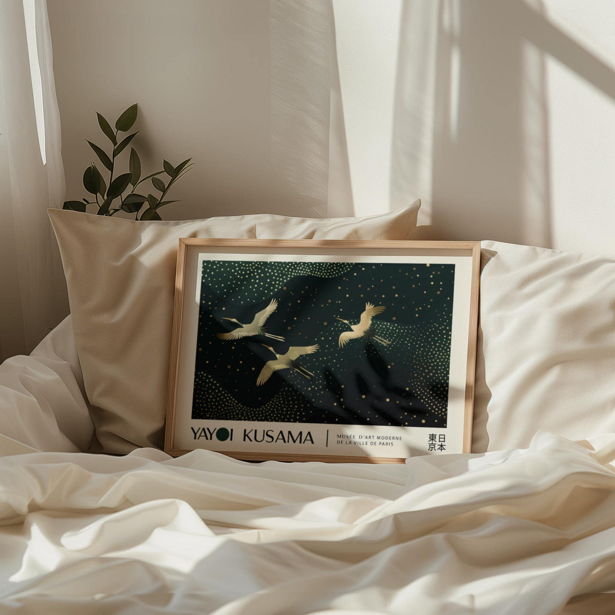 Japanese Art Print framed print with golden cranes and abstract dots in beige frame leaning on bed cushions