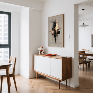 Print on a wall of black and gold abstract shapes above a sideboard in a dining room