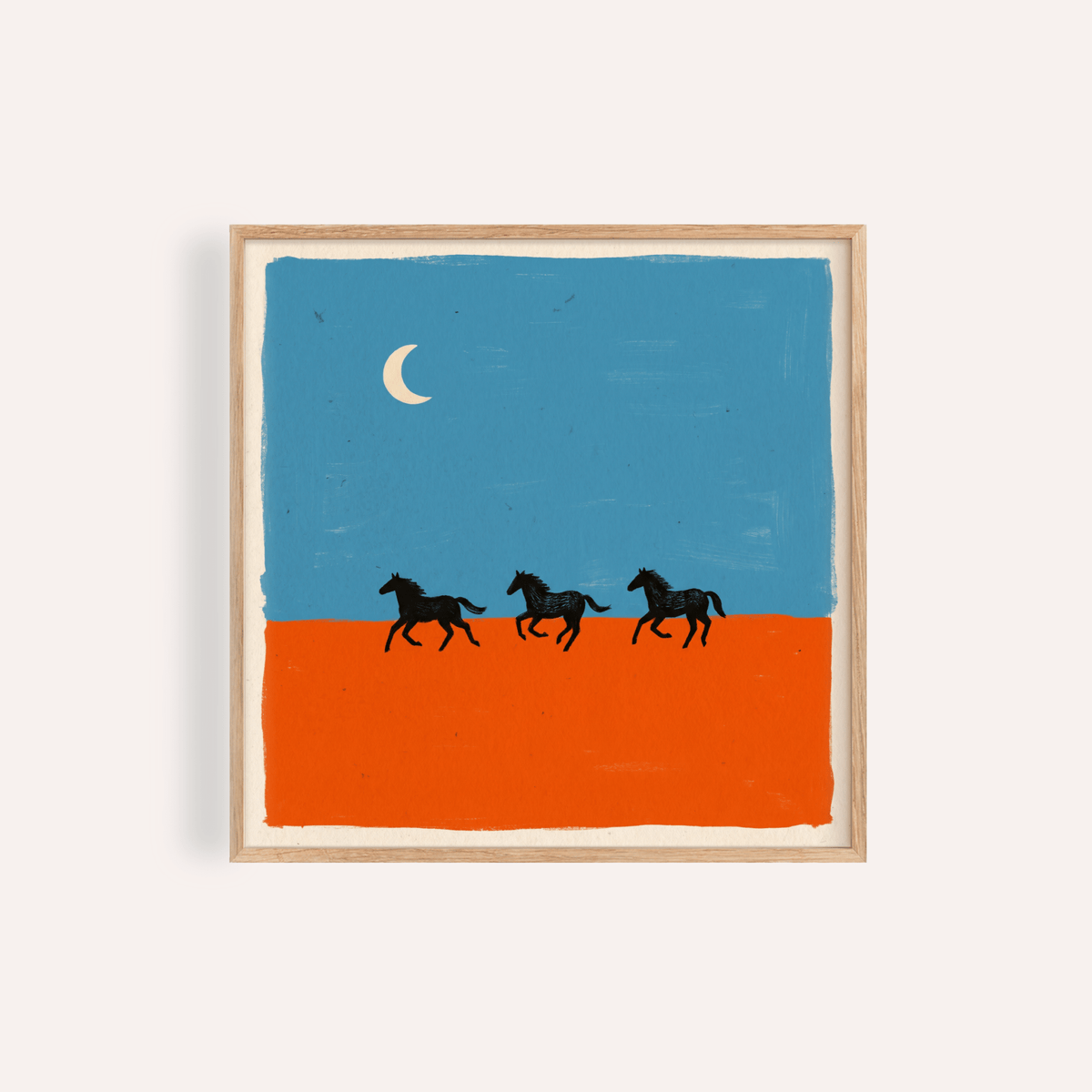 Framed horse silhouette wall art of three black horses running on an orange ground under a blue sky with a crescent moon