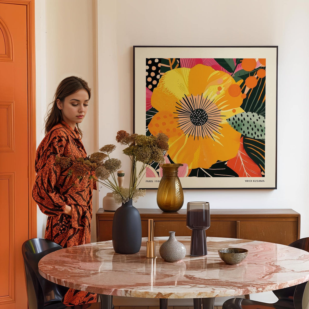Yellow Flower Art print on a cream wall in a dining room with a round marble table and vases