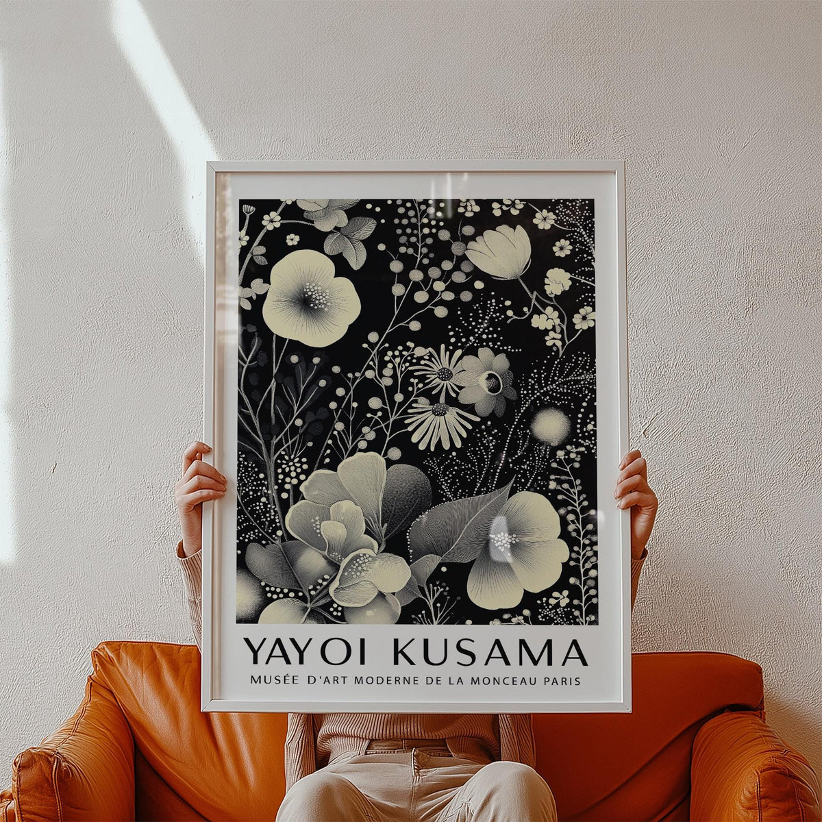 Large Floral Wall Art held in hands showing ivory floral pattern on black background