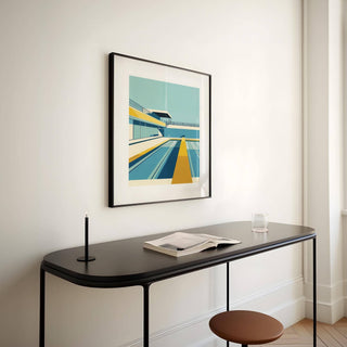 Pool print framed print on a light wall above a black console with a candle and open book