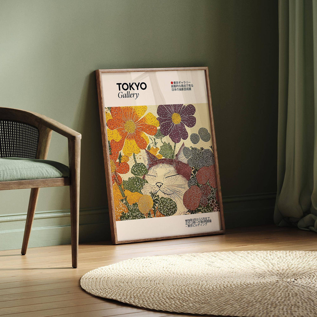 Japanese Artwork leaning framed with a sleeping cat and colourful flowers beside a green chair