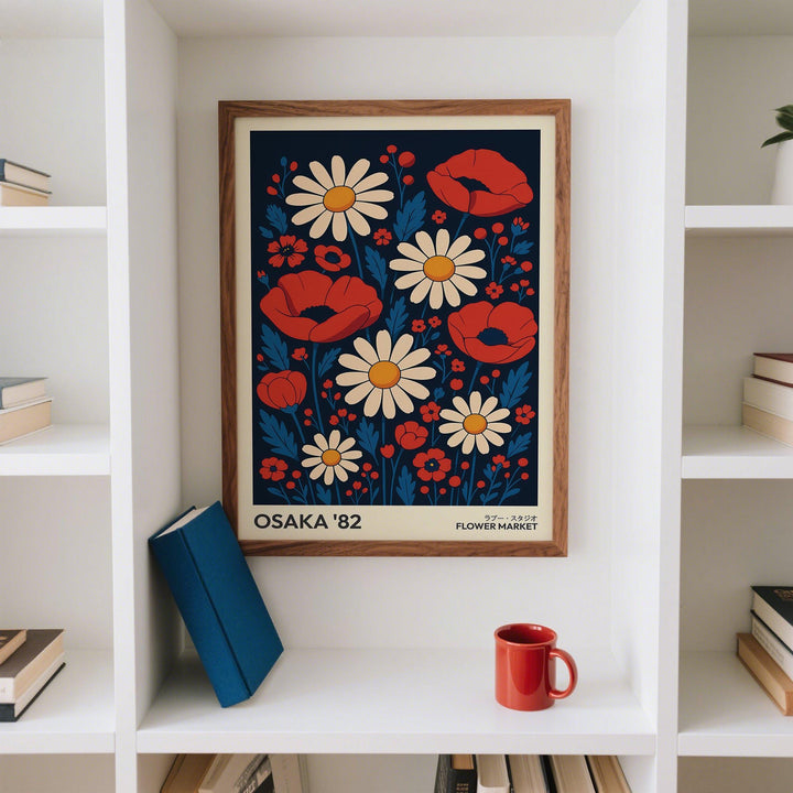 Retro flowers art print of red poppies and cream daisies framed on a white shelf with a red mug