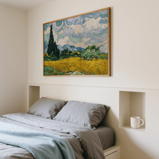 Cypress Tree Landscape print in blues and yellows above a bed with grey bedding and a mug on a shelf