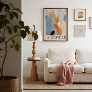 Blue Pink wall art of abstract botanical leaves in soft blue and pink tones above a wooden side table and lamp
