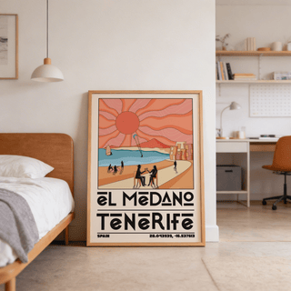 Print leaning on a floor showing a Tenerife Travel Poster beach scene with a large sun and pastel colours in a bedroom