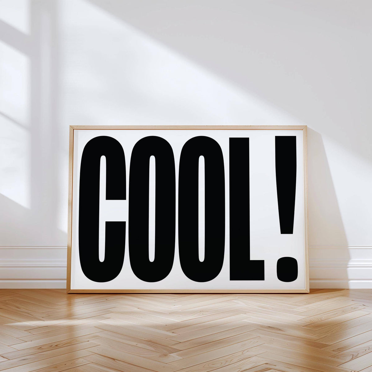 Cool Typography Poster leaning on a wooden parquet floor with sunlight and shadows