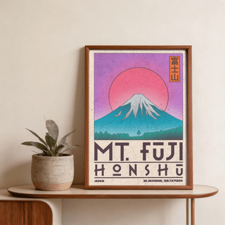 Framed Mt Fuji Art Print leaning on a wooden table next to a small potted plant