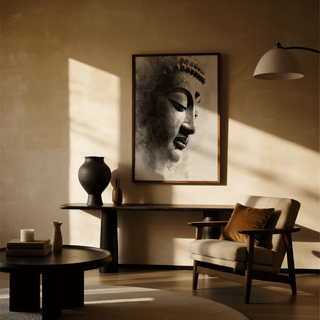 Zen Statue Face Art Print in muted greys hangs above a dark console table with a black vase in a warmly lit sitting room