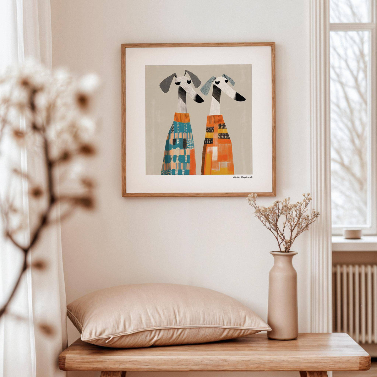 Wall Art Dog of two greyhound dogs in colourful jumpers in a softly lit room with a vase