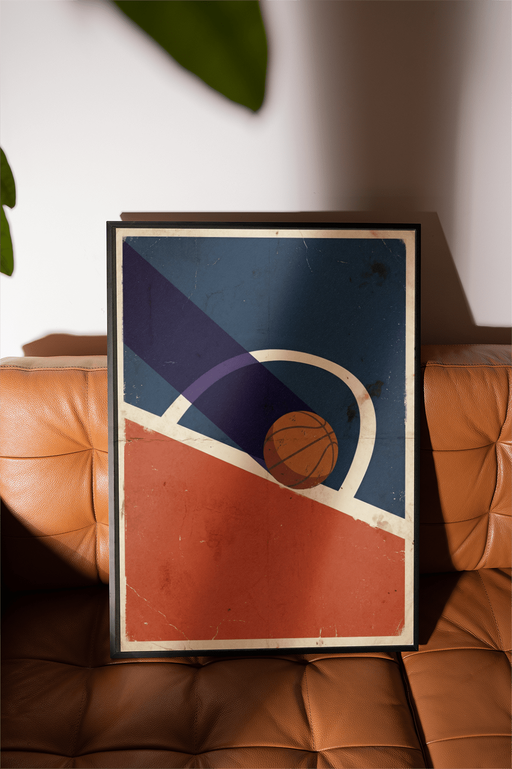 Vintage Basketball Poster leaning on a brown leather seat shows a basketball entering the hoop with a vintage style