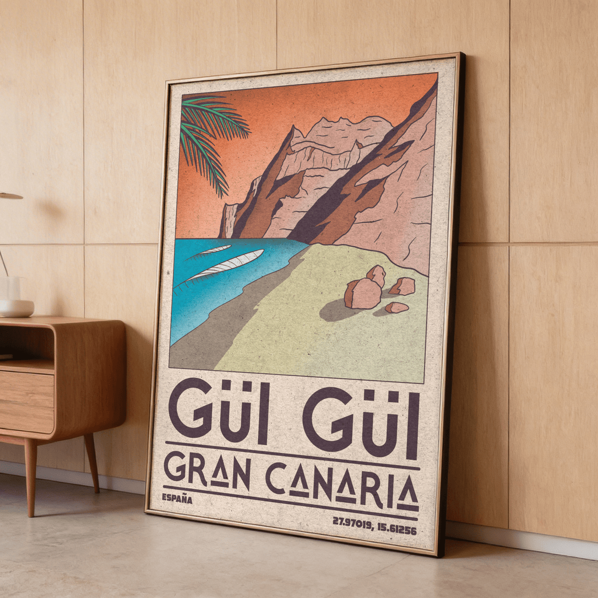 Gran Canaria beach art print leaning against a wooden wall with mid-century style cabinet nearby
