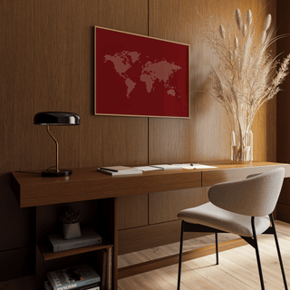 World Map Wall Poster framed print above a desk with a black lamp and dried flower arrangement