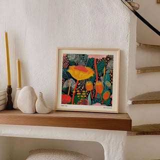 Floral Prints for Framing leaning print with bright abstract floral pattern beside white sculptures on a shelf