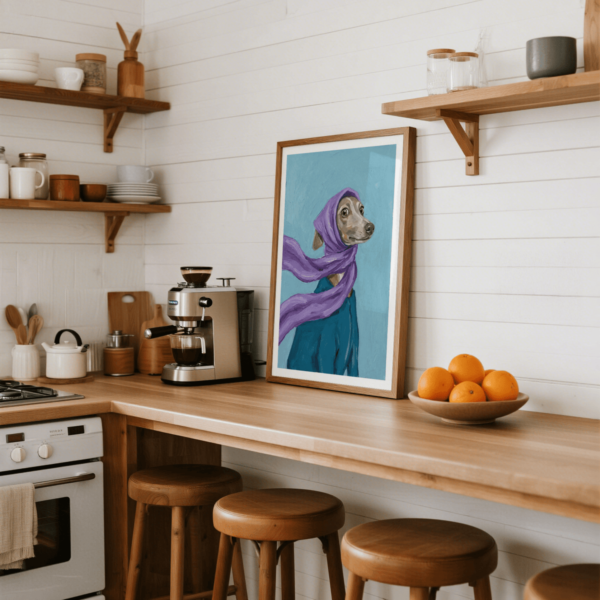 Dressed Up Dog Art print leaning on a kitchen wooden counter with a bowl of oranges nearby