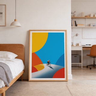 Cycling art print of a cyclist on a curved road with bright blue yellow and red shapes leaning on the floor next to a bed