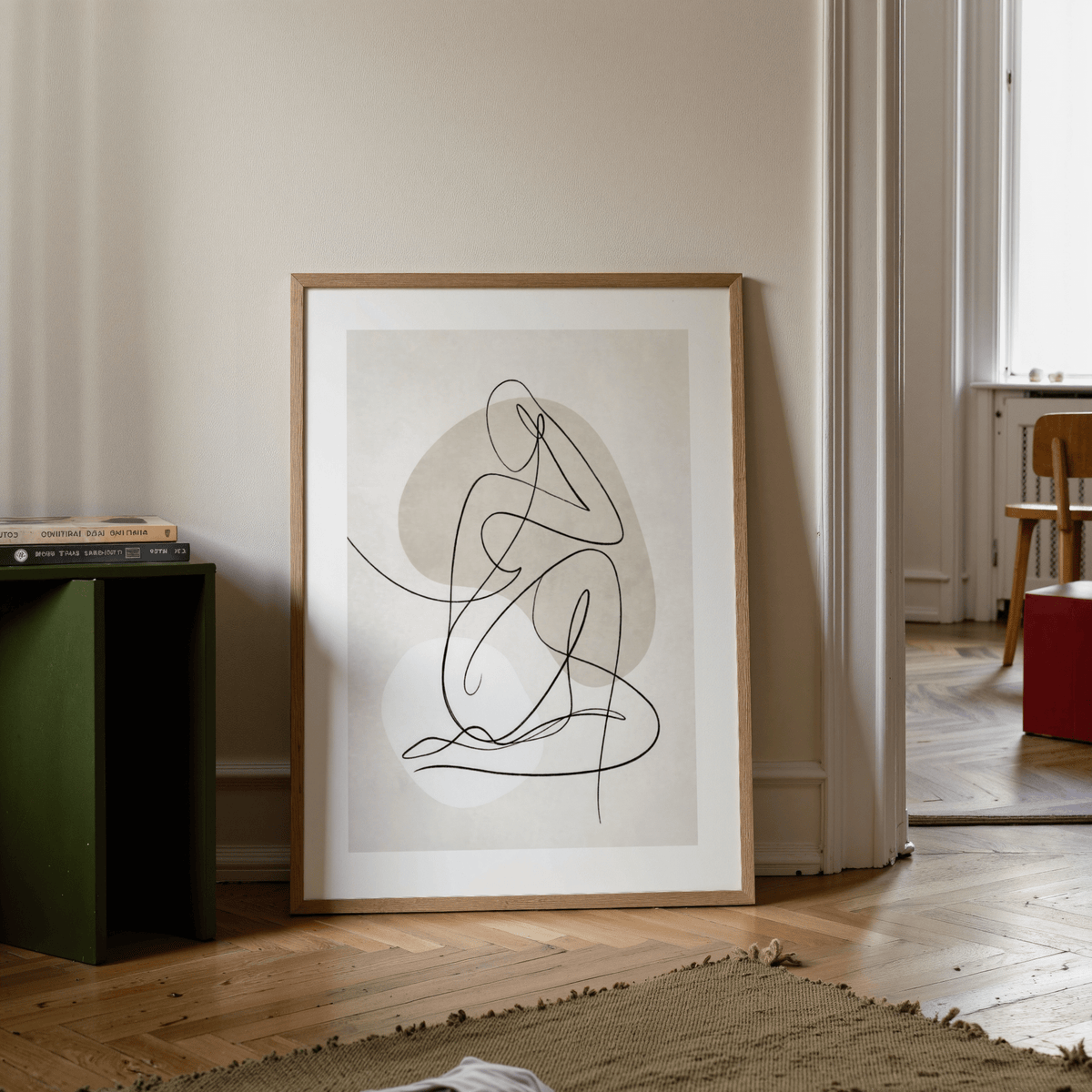 Abstract Line Art Poster leaning on wooden floor with abstract seated figure in beige and white shapes