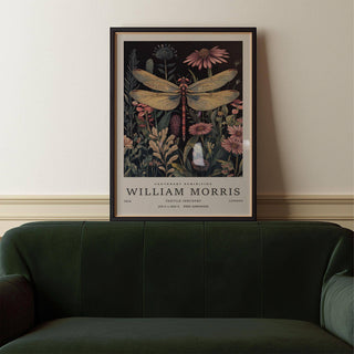 Framed Dragonfly Art Prints above a green velvet sofa showing a vintage dragonfly with pink flowers