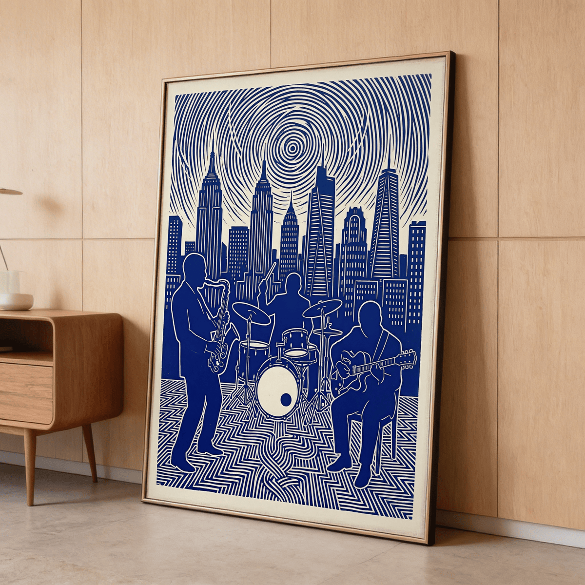Framed jazz band wall art in blue and cream leaning against a light wooden wall with a shelf nearby