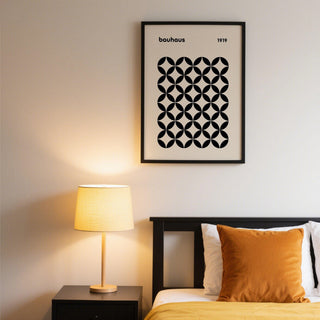 Mid Century Wall Print of a black geometric grid in bauhaus style above a black bed with a brown cushion