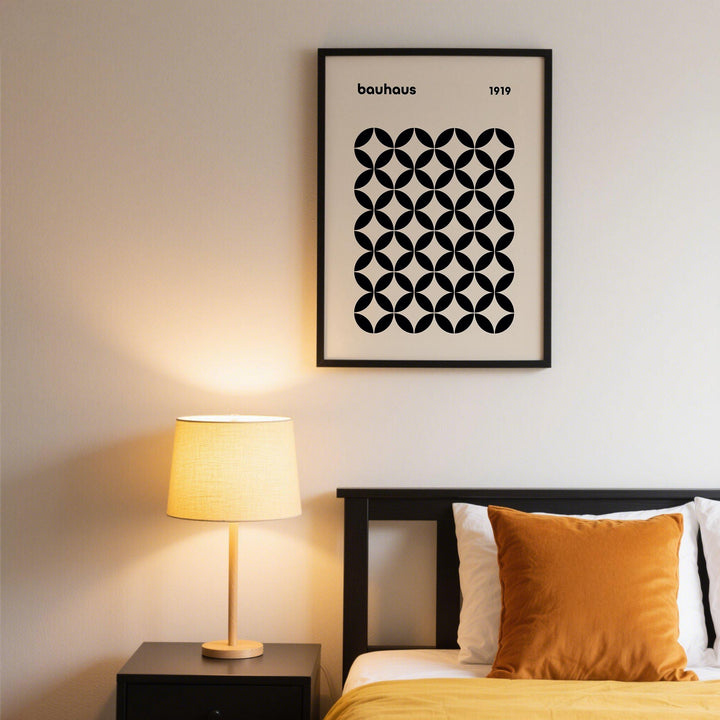 Mid Century Wall Print of a black geometric grid in bauhaus style above a black bed with a brown cushion