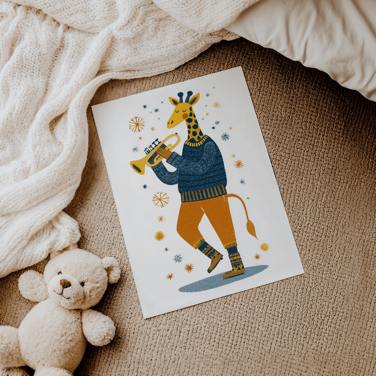 Giraffe Music Art Print on a carpet with a knitted blanket and teddy bear nearby