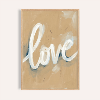 Close-up of love wall art with white calligraphy on a beige background in a wooden frame