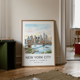 New York City wall art leaning on floor beside a green side table with books in a room