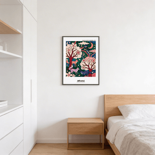 Print of foxes in a sakura garden with pink blossoms and green leaves above a wooden bedside cabinet in a bedroom