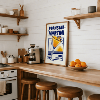 Retro Passion Fruit Martini Poster leaning on a kitchen counter with wooden stools and fruit bowl