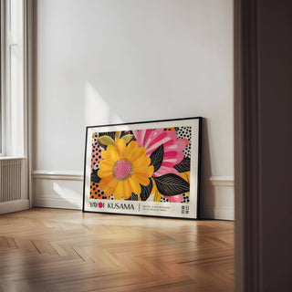 Print leaning on wooden floor of a bright yellow flower pop art illustration with pink accents
