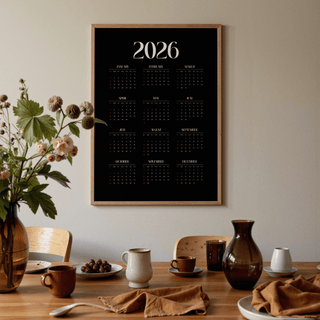 Modern Calendar Print in a wooden frame over a dining table with brown ceramics and a flower vase