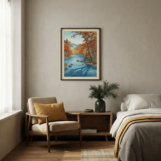 Framed print of a Japanese woodblock autumn river valley above chest in a bedroom with armchair