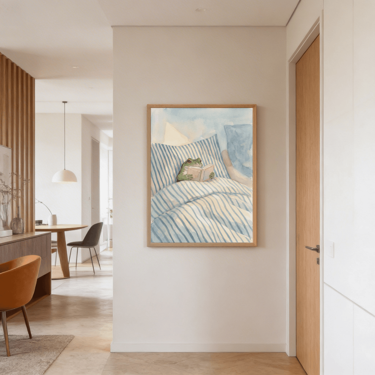 Frog Reading In Bed Print hanging in a hallway with wooden door and open dining area