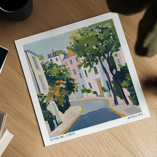 Notting Hill Poster showing a watercolour style illustration of a street with green trees on a wooden table
