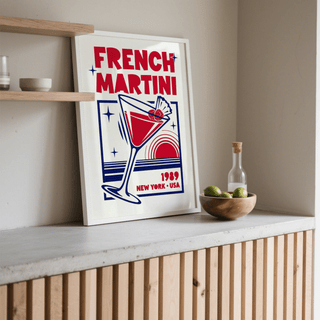 French Martini Poster print leaning on surface with retro typographic illustration in red and blue near a bowl of limes