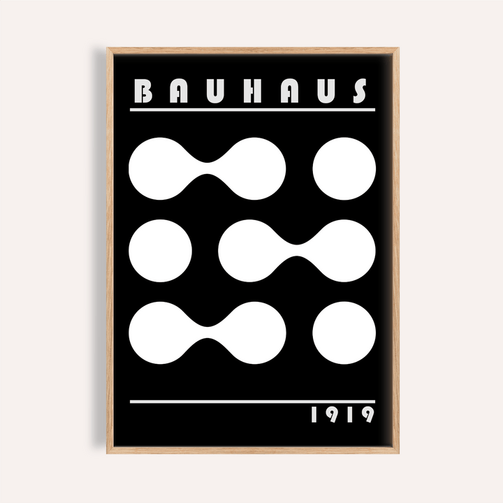 Framed Abstract Geometric Print with white shapes on a black background and Bauhaus text