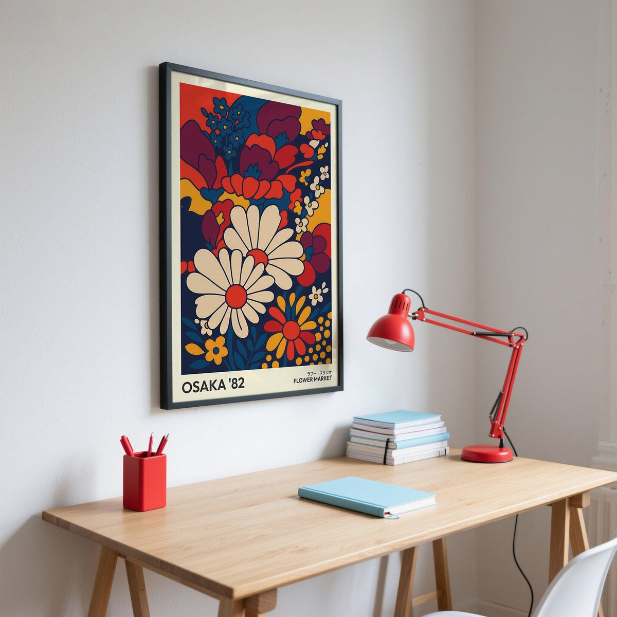 Framed Retro Wall Art Prints of daisies and flowers in red blue and yellow above a desk with a red lamp
