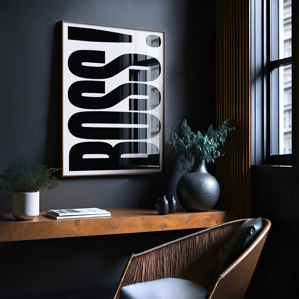 Office wall art with BOSS typography in black and white above a wooden desk with plants