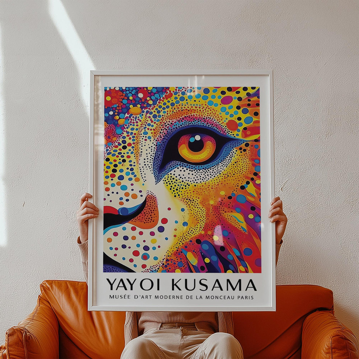 Framed Lion Animal Poster showing a colourful dotted lion face held above an orange armchair