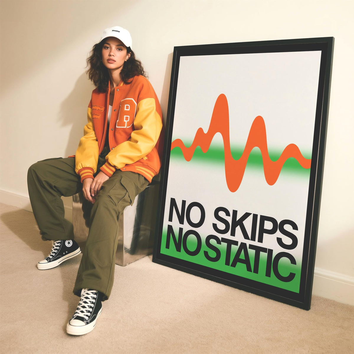 Framed Retro Music Poster print leaning on the floor with orange and green waveform and black text