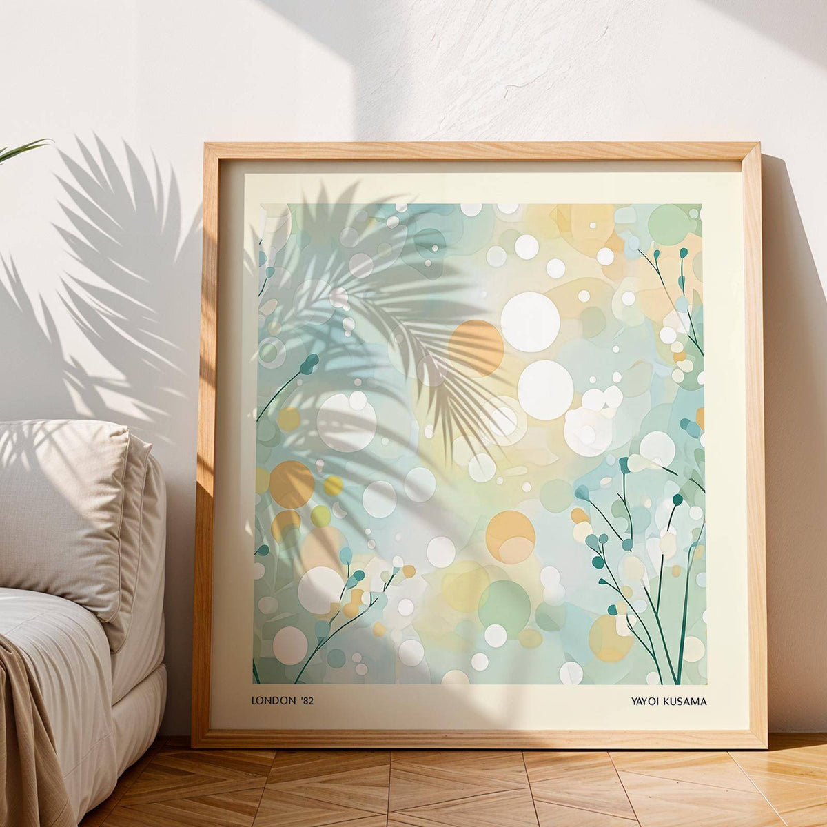 Framed Sitting Room Wall Art with soft abstract circles and dots in pastel hues beside a cream sofa