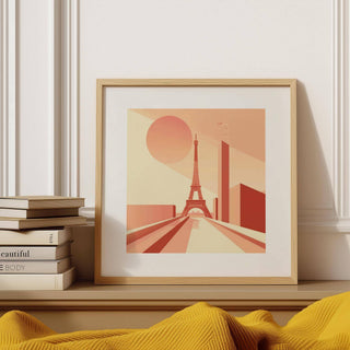 Framed Eiffel Tower Poster Wall Art in bauhaus style with pink and beige tones by a stack of books