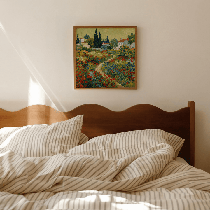 Flower Garden Art Print framed on a wall above a bed with striped bedding in soft natural light