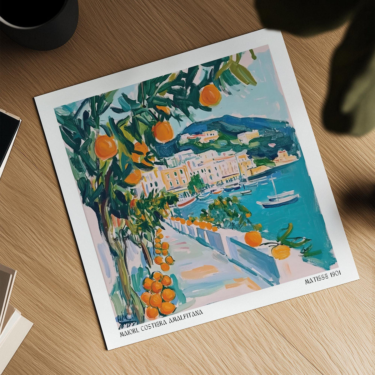 Art print on table of an orange tree by a seaside path in bright colours