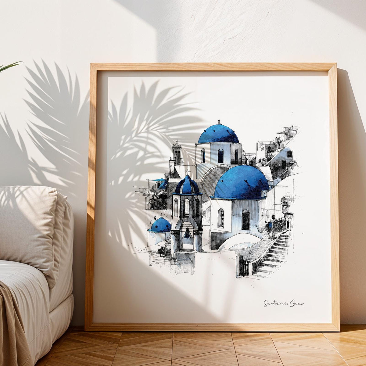 Print leaning on floor of Santorini wall art showing blue domed churches with palm shadow nearby