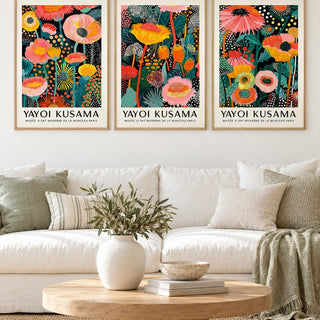 Floral Prints Set of 3 hung at eye level above a white linen sofa: Petal Paradise, Lush Tropica and Botanical Glow shown framed side by side (frames not included)