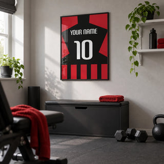 Football Shirt Poster in Black and Red Stripes, framed on the wall of a compact home gym in a UK terrace with a light grey wall and plain dark rubber flooring