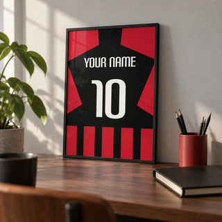 Football Shirt Poster in Black and Red Stripes, a small A4 framed print leaning on a walnut desk